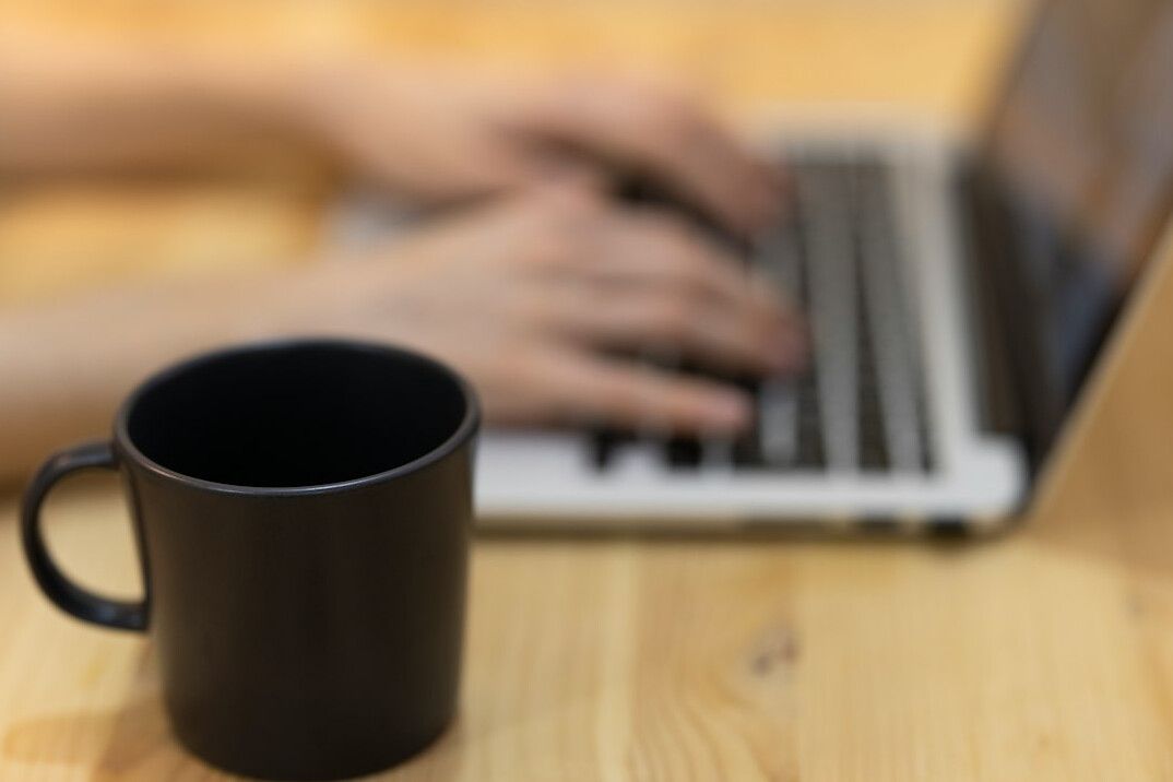 person studying at desk with laptop